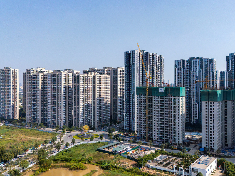 Modern luxury apartment building with balconies in Hanoi, attracting foreign buyers.