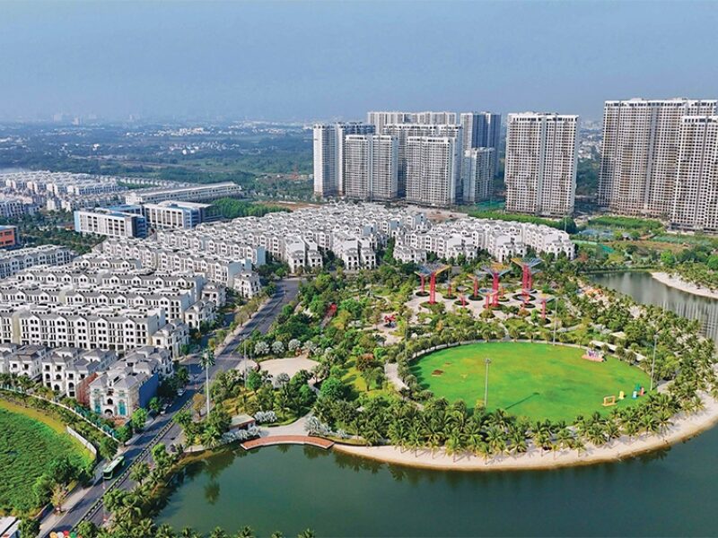 Vietnam real estate M&A boosts urban developments with lush parks and high-rise apartments overlooking a serene lake
