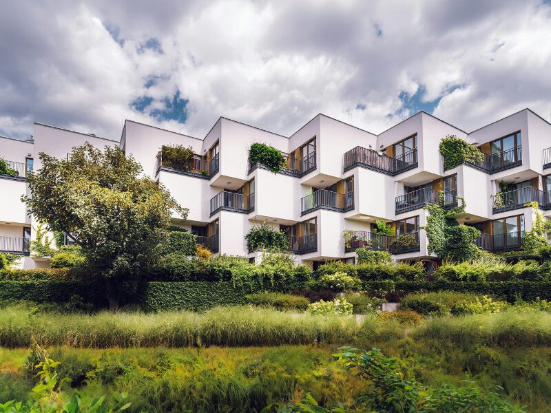 Modern green residential complex showcasing Ho Chi Minh City foreign investment in sustainable urban architecture with lush balconies and surrounding greenery.