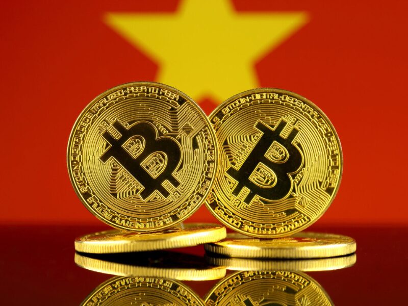 Two golden Bitcoin coins with the Vietnam flag in the background, symbolizing Vietnam Crypto Regulations