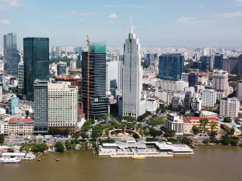Aerial view of Ho Chi Minh City real estate skyline featuring modern skyscrapers like Bitexco Financial Tower along the Saigon River, highlighting booming Ho Chi Minh City real estate opportunities for foreign investment.